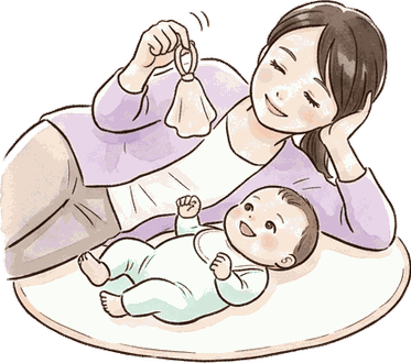 プレイマットに寝ころぶ赤ちゃんの横でママも寝そべり、布のおもちゃを揺らしている絵