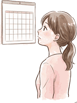 壁のカレンダーを見て予定を確かめているママ
